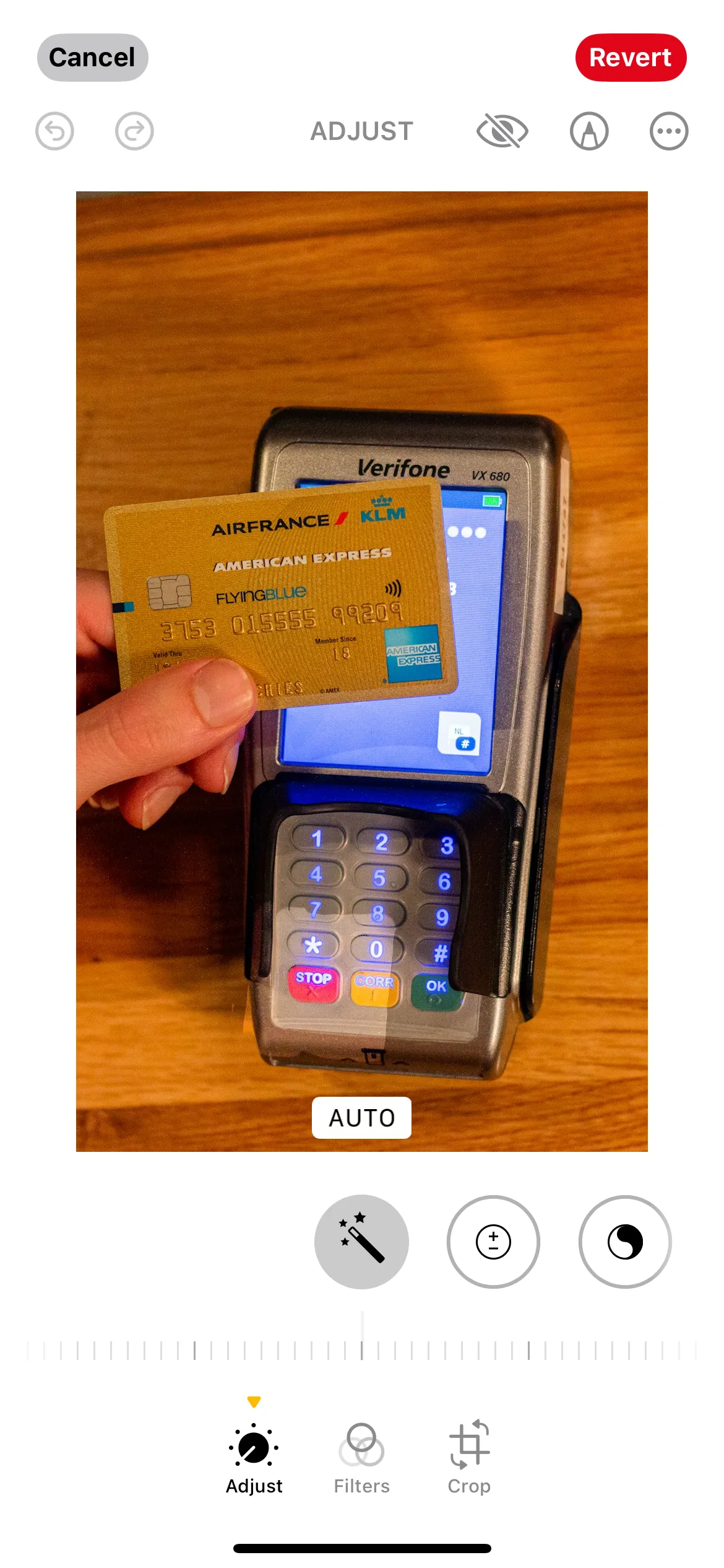 iPhone Photos app showing photo of a credit card