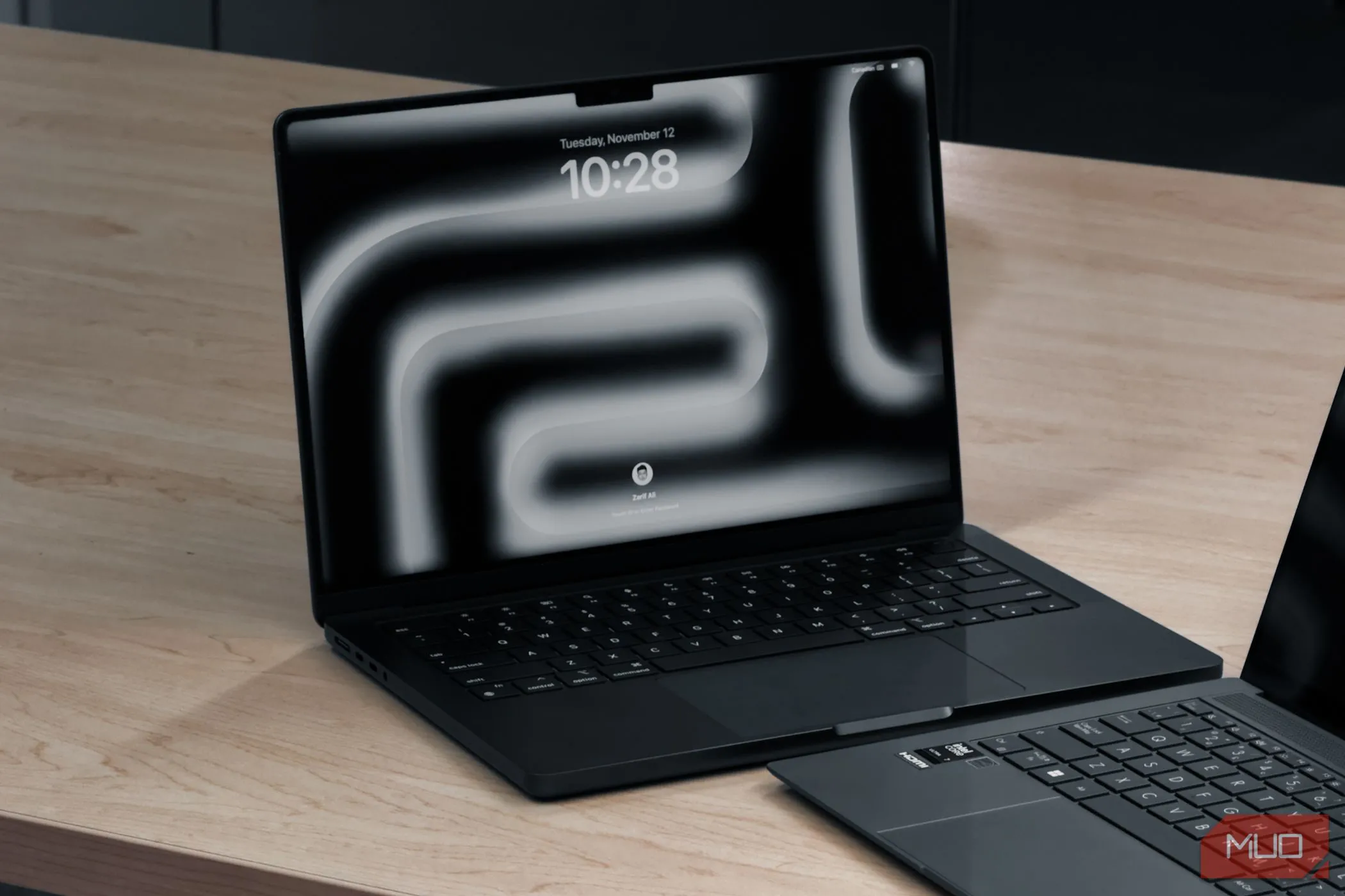 MacBook Pro M4 và một laptop khác trên bàn gỗ
