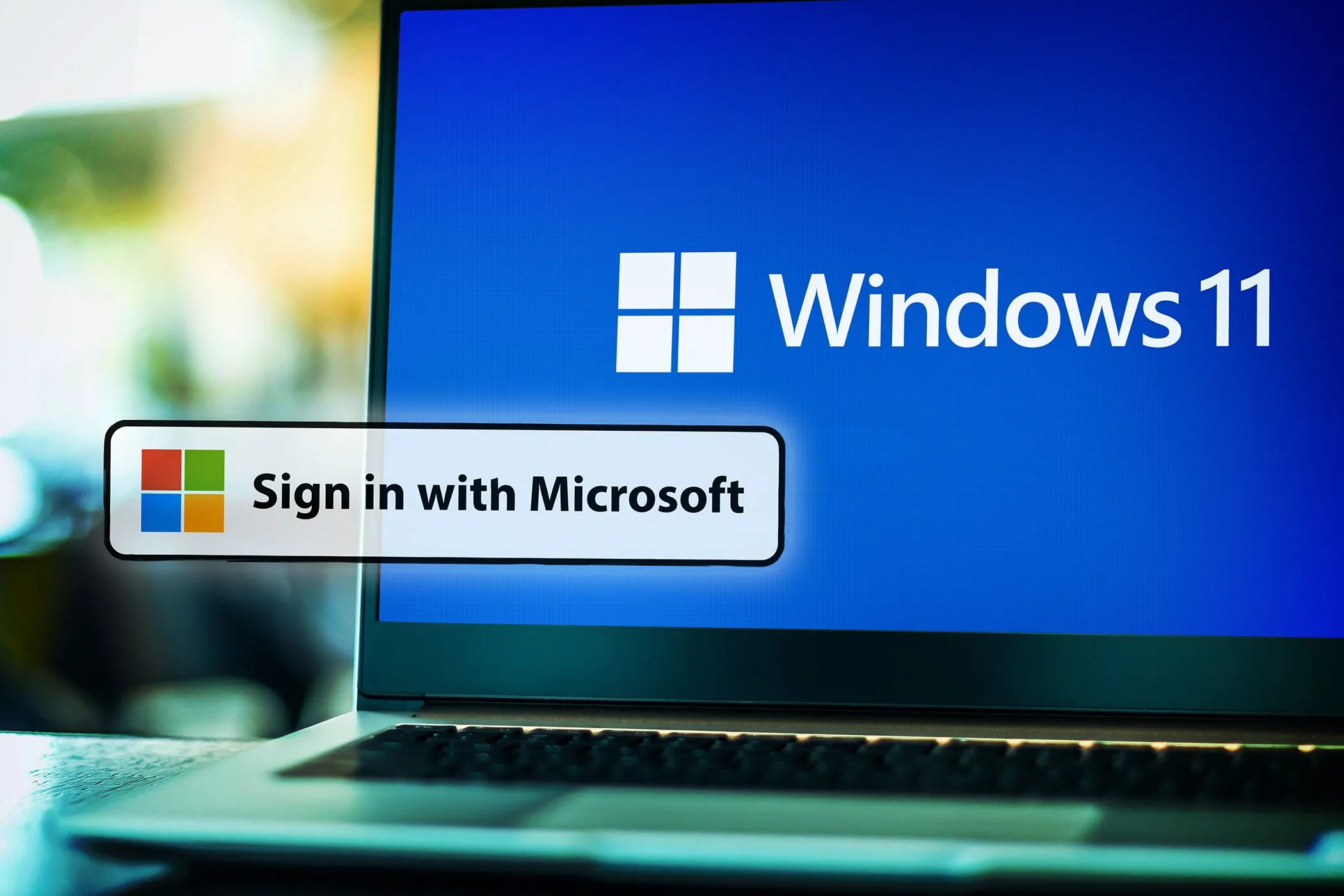 Màn hình laptop hiển thị Windows 11 cùng các biểu tượng đăng nhập của Google, Facebook, Apple, minh họa sự khó khăn khi chuyển đổi nhà cung cấp dịch vụ đăng nhập.