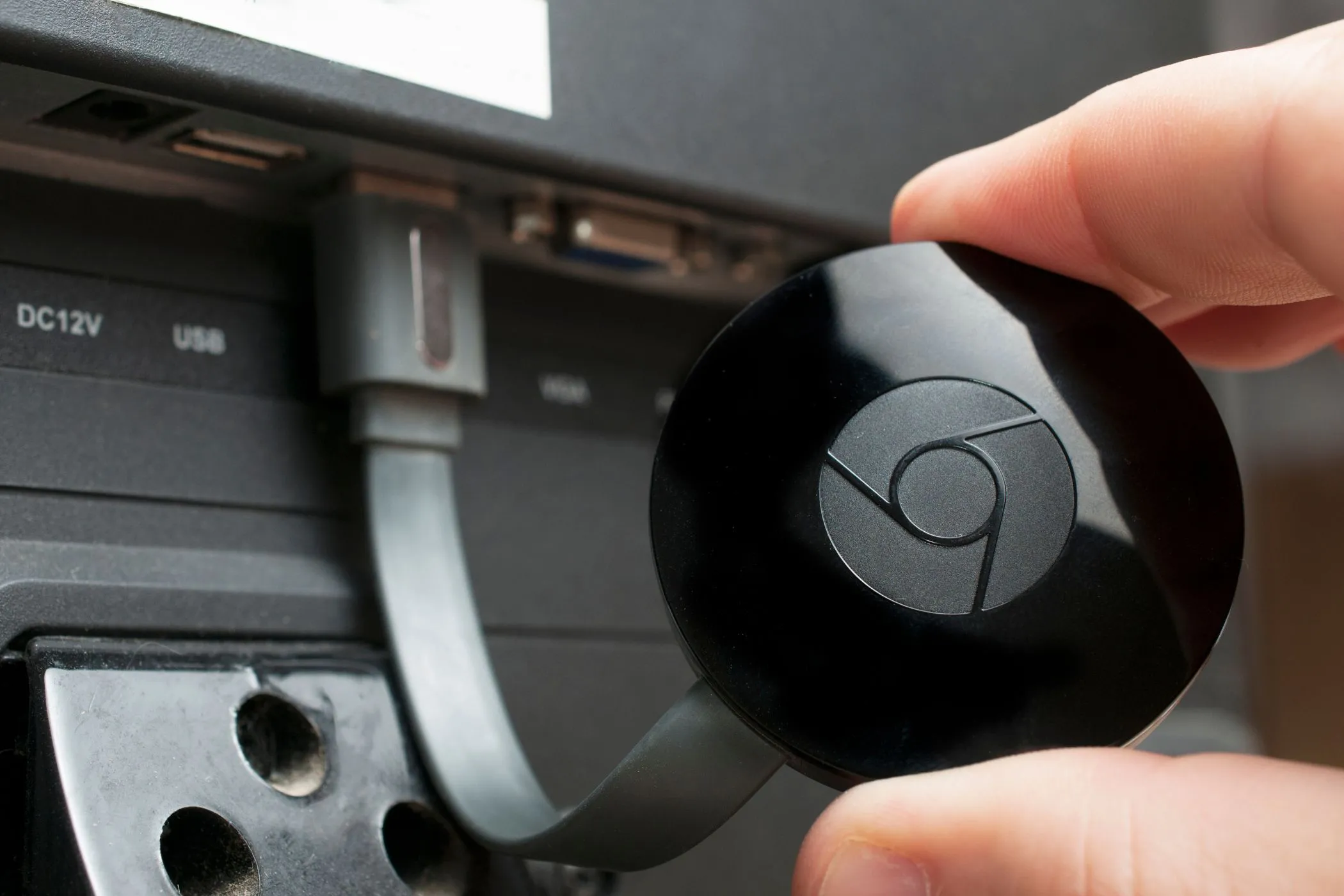 Thiết bị Google Chromecast được cắm vào cổng HDMI của TV, sẵn sàng để chiếu nội dung từ iPhone
