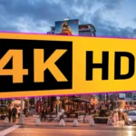 Logo HDR 4K trên màn hình hiển thị cảnh đường phố đêm với ánh sáng rực rỡ, minh họa sự khác biệt của công nghệ HDR